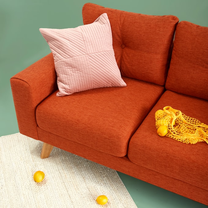 Layered decorative pillow composition on a linen sofa